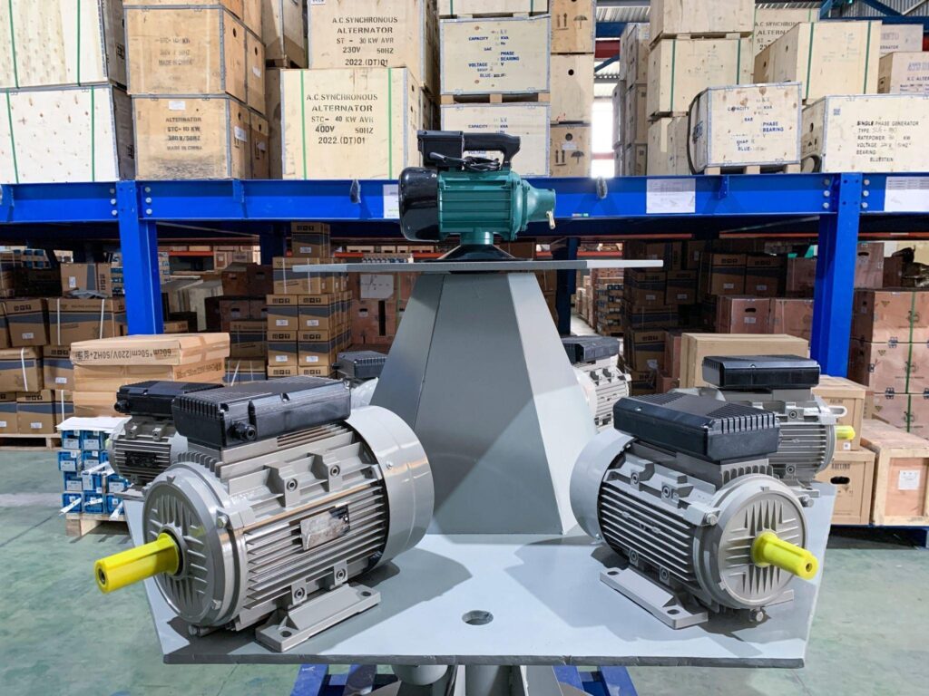 Industrial electric motors mounted on a test stand in a warehouse facility.
